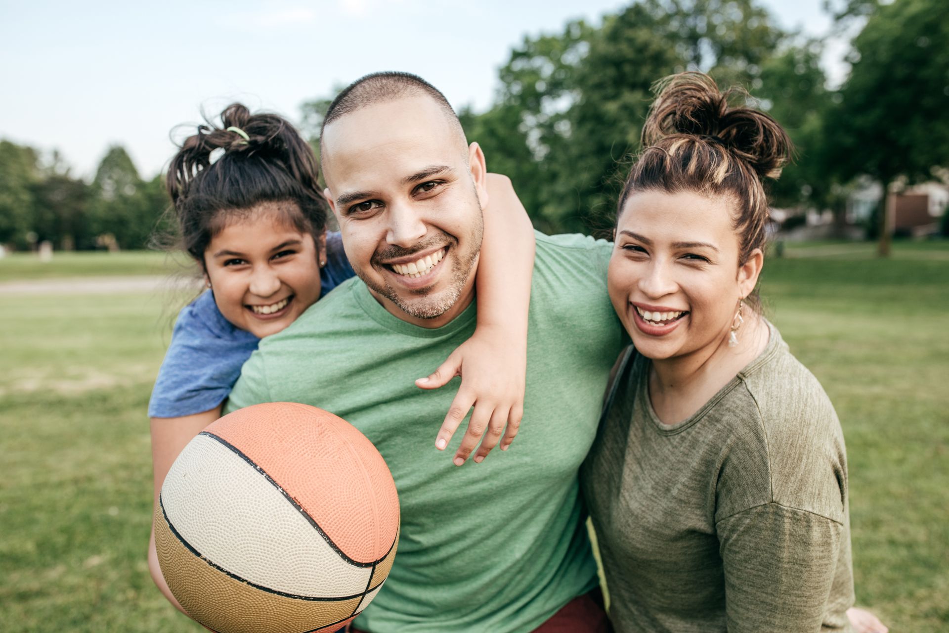 Family of three playing basketball